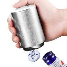 a hand holding a can opener and two bottles