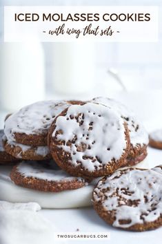 iced molasses cookies with icing that sets on a white plate next to a glass of milk