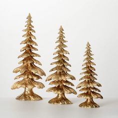 three gold pine trees sitting next to each other