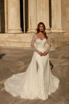 a woman in a wedding dress posing for the camera