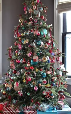 a decorated christmas tree with presents under it