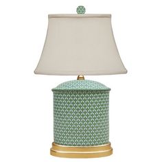 a green and gold lamp with a white shade