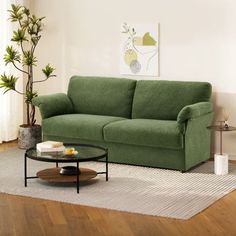 a living room with a green couch and coffee table