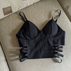 Sexy, Black, Sleeveless Cutout On Sides Crop Top. Brand New, Smoke-Free Home. Black Crop Top Outfit Party, Black Cami Crop Top For Club, Black Cami Crop Top For Night Out, Black Tank Top With Built-in Bra For Club, Black Tank Strap Top For Club, Edgy Crop Top Tank Top For Party, Edgy Black Tank Top With Built-in Bra, Black Tank Straps Crop Top For Club, Black Crop Top Tank Top For Club