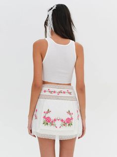 For a busy vacation itinerary, the Jolene mini skirt has chic, everyday appeal. Featuring beautiful pink floral embroidery and lace trims, this white cotton mini skirt can be styled as a co-ord skirt set when paired with the Jolene Embroidered Top. Fit Notes The Jolene Embroidered Mini Skirt is fitted at the waist and flares out slightly through the hip. We suggest taking your regular size. Style Notes Fully lined Functional skinny tie closure at the left side seam Fabric + Care Crafted in 100% Co Ord Skirt, White Rehearsal Dress, Cotton Mini Skirt, Vacation Itinerary, Perfect White Tee, Linen Bottoms, Silk Jumpsuit, Silk Bottoms, Trendy Denim