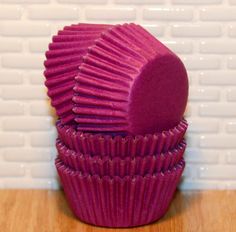 three purple cupcake cases stacked on top of each other