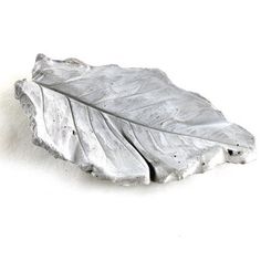 a silver leaf on a white background