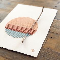 a piece of paper that is on top of a wooden table with wires attached to it