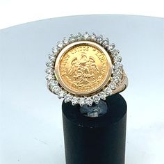 Featuring our vintage 14k (karat) yellow gold ring with a center 22k (karat) gold peso coin and 0.90 carat total weight diamond halo. Material/Metal: 14k (karat) yellow gold (ring mounting and shank) and 22k (karat) yellow gold (peso) Stones: 0.90 carat total weight round brilliant cut diamonds Size: 10.5 US / 62 EU / U UK Style: vintage jewelry, gold peso, peso jewelry, coin jewelry, 22k coin, solid gold coin, gold coin, gold coin jewelry, coin ring, gold coin ring, diamond ring, diamond coin jewelry Condition: vintage, gently preowned and professionally cleaned and polished Gold Coin Ring Vintage, Yellow Gold Coin-shaped Hallmarked Rings, 14k Gold Coin-shaped Rings, Cheap Vintage Coin-shaped Jewelry, Gold Coin Jewelry, Vintage Coin-shaped Tarnish Resistant Jewelry, Gold Coin Ring, Ring Mountings, Coin Ring