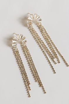 The London Gold Rhinestone Fringe Earrings are the best way to complete any exceptionally elegant outfit! These trendy earrings start with a rhinestone semi-circle stud post back and fall to rhinestone fringe chains. Add these fun earrings to a black dress + heels to add a chic touch to your date night look! Gold Plated Rhinestones Fringe Stud Post Back One Size | Length 3” Elegant Semi-circle Metal Earrings, Elegant Semi-circle Metal Jewelry, Black Dress Heels, Black Dress With Heels, Rhinestone Fringe, Dress Heels, Earrings Trendy, Circle Studs, Trendy Earrings