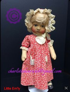 a doll with blonde hair is wearing a red dress and white shoes, standing in front of a black background