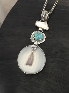 "ARTISAN DRUZY TURQUOISE GEMSTONE PENDANT Hand-made Sterling Silver 925. Stones used: Agate Druzy, Turquoise , Pearl, Iolite Height -100mm (with bail), Width - 40mm Height - 4', Width - 1 5/8' Unique Handcrafted One-of a-kind Design Pendant, Wearable Art. Each Piece of Jewelry in my Collection is Absolutely One of a Kind! When you start wearing a piece of my jewelry you will fall in love with it more and more each day and feel that good Energy and Love that I pass into it while creating this pie Turquoise Agate Pendant Jewelry, White Fusion Pendant Jewelry, White Fusion Style Pendant Jewelry, Bohemian Jewelry With Rectangular Gemstone Pendant, Elegant Turquoise Necklace For Gift, Artisan Jewelry Pendant With Gemstone Accents, Artisan White Turquoise Necklace As A Gift, Artisan Pendant Jewelry With Gemstone Accents, Elegant Turquoise Pendant Necklace With Natural Stones