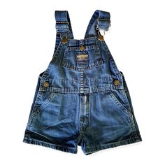 An exciting find for the vintage lover! These short overalls are in great shape, with a broken-in look and feel. The mid-wash blue denim is subtly printed with tiny red flowers with green leaves. The print is more faded in some areas. Buttons at the hips, snap chest pocket, back patch pockets. RUNS SMALL, more like a large 2T or small 3T. Made in U.S.A. 100% cotton Machine wash & dry Vintage Denim Blue Cotton Shortalls, Dark Wash Denim Bib Front Shortalls, Denim Shortalls In Medium Wash With Bib Front, Cotton Medium Wash Shortalls Overalls, Vintage Denim Shortalls With Bib Front, Cotton Medium Wash Shortalls, Retro Denim Bib Front Shortalls, Vintage Bib Front Shortalls For Spring, Medium Wash Cotton Overall Shortalls