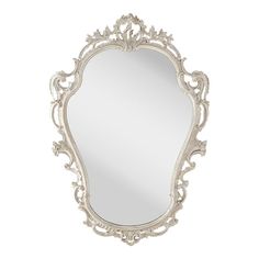 an ornate white mirror on the wall