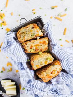 four cheesy breads in a pan on a blue towel