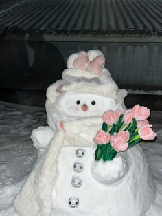 a snowman with flowers in its hand