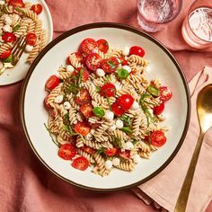 two plates of pasta with tomatoes and mozzarella