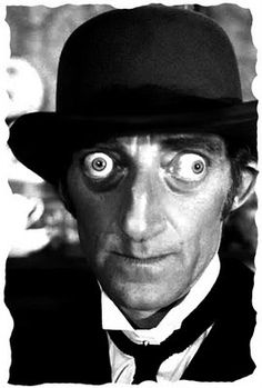 a man with big eyes wearing a top hat