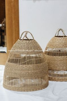 two woven baskets sitting on top of a table