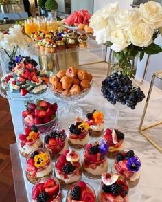 a table topped with lots of desserts and flowers