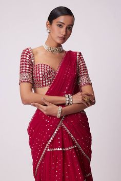 Crimson red pre-draped tiered lehenga saree with all over gold toned quad sequin embellishments and mirror borders. Paired with a half sleeves sweetheart neck mirror jaal embroidered blouse. - Aza Fashions Fitted Pre-draped Saree With Gota Work, Floor-length Pre-draped Saree For Diwali, Floor-length Pre-draped Saree With Gota Work For Festivals, Festive Pre-draped Saree With Gota Work, Fitted Pre-draped Saree With Gota Work For Wedding, Red Pre-draped Designer Saree For Festive Occasions, Bollywood Style Designer Red Pre-draped Saree, Fitted Pre-draped Saree With Gota Work For Designer Wear, Party Pre-draped Saree With Gota Work