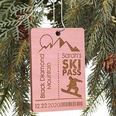 a pink ski pass ornament hanging from a tree