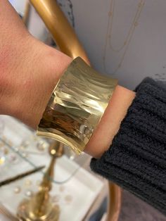 Gold-plated over brass. Adjustable. Gold Polished Cuff Bracelet, Modern Brass Cuff Bangle, Gold-tone Metal Cuff Bracelet, Tarnish Resistant, Modern Gold Hammered Cuff Bracelet, Modern Hammered Gold Cuff Bracelet, Elegant Bronze Metal Cuff Bracelet, Modern Gold Cuff Bracelet With Wide Band, Modern Gold Wide Band Cuff Bracelet, Polished Brass Bangle Cuff Bracelet