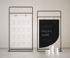 two black and white signage stands next to each other