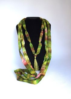 Long necklace in chartreuse green and pink hand-painted silk This necklace is made with silk scraps from my scarves. It is made of 3 different necklaces, to wear together or separately The two largest can be worn as a cuff bracelet I added on the smallest necklace, a chartreuse green pompom topped with a wooden bead, which gives it a chic bohemian side * 100% silk * Necklace length: 194 cm * Width: 3 cm * High quality French paintings *Heat fixed to preserve colors * Made in Lyon * green, chartreuse green, spring green, brown  Wedding Anniversary, Birthdays Packaging : Ready for gifting - carefully packaged in natural tones tissue paper and business card Sending : by tracked letter for France and by registered parcel for international destinations Packaging : carefully packaged in tissue p French Paintings, Silk Necklace, Chartreuse Green, Small Necklace, Brown Wedding, Chic Bohemian, Painted Silk, Necklace Green, Hand Painted Silk