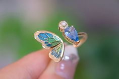 "Introducing our stunning Aquamarine Butterfly Ring - the perfect anniversary gift for that special someone or a lovely treat for yourself. 🦋💍 100% High-quality Natural Aquamarine Gemstones  💎100% High-quality Natural Diamonds 💎  ----------------------♡-------------------- Ring Setting: ●Main stone: 1.0 ct Natural Aquamarine Gemstone ●Material: 18k Gold ●Free Jewelry Certification: A globally recognized certification will come with this fine gem jewelry ●Packaging: All items are nicely packaged ready to gift in elegant jewelry boxes ----------------------♡-------------------- Important Note: ●Since every piece of jewelry is unique and made-to-order for you, the sizes of stones and metal weights may vary slightly. ----------------------♡-------------------- Processing & Free Shipping: ● Luxury Enamel Gemstone Ring For Gift, Luxury Butterfly Ring With Gemstone For Wedding, Luxury Gemstone Butterfly Ring As Gift, Luxury Gemstone Butterfly Ring For Gift, Luxury Butterfly Ring With Gemstone For Gift, Blue Enamel Ring With Polished Finish As Gift, Blue Enamel Ring With Polished Finish For Gift, Elegant Enamel Open Ring Jewelry, Luxury Enamel Rings Perfect As Gifts