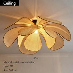 the ceiling light is made out of metal and has an intricate flower design on it