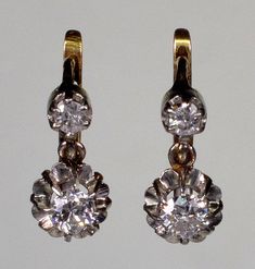 A splendid pair of French 18K gold platinum diamond earrings from Edwardian period C.1900. The earrings measure 12 mm high 6 mm wide. The diamonds are old European cut. The bottom ones measure 3.5 mm diameter or 0.15 Ct. The top diamonds are 2.5 mm or 0.15 Ct. The diamonds are set in platinum. The back of the earrings and the lever back clasps are 18K gold. The earrings are hallmarked with eagle - the French stamp for 18K gold. Platinum acid tested. Total weight is 2.9 grams. Excellent antique c Classic Gold Hallmarked Diamond Earrings, Classic Gold Diamond Earrings Hallmarked, Classic Gold Earrings With Single Cut Diamonds, Formal White Gold Diamond Earrings With Single Cut Diamonds, Formal White Gold Diamond Earrings With Single Cut, Classic Hallmarked Yellow Gold Diamond Earrings, Antique Hallmarked Earrings For Anniversary, Formal Hallmarked Diamond Earrings, Classic Diamond Drop Earrings With 17 Jewels