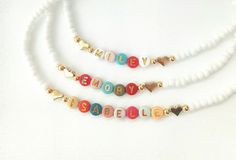 This darling name necklace is so sweet, colorful and surely will make a perfect birthday gift, Christmas gift or and every day favorite accessory  100% made to order and handcrafted with excellence and precision into a beautiful, personalized name necklace that is so special and perfect for gift giving. Arrives in a white gift box with a bow ready for gifting. The colorful beads are carefully chosen to form a random color design for a personalized style. We use strong stretch cord to string the beads on. Because this necklace is a stretchy it does not require a clasp which makes this beautiful, dainty, personalized name necklace easy to put on and easy to take off.  NECKLACE LENGTHS  12, 13 and 14 inches for toddlers and children  15, 16 and 18 inches for adults. MATERIALS  letter beads wh Bead Name Necklace, Beaded Name Necklace, Christmas Toddler, Necklace With Heart, Toddler Christmas, Letter Beads, White Gift Boxes, Toddler Kids, Beaded Necklaces