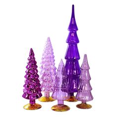 several different colored glass trees on a white background with one purple and one gold stand out from the crowd