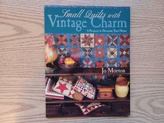 small quilts with vintage charm book sitting on a table