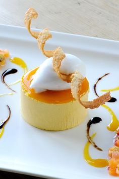 a white plate topped with an orange dessert