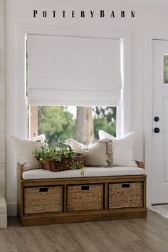 a window seat with baskets underneath it and the words pottery barn above it in white