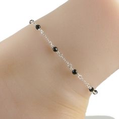 This elegant anklet features black Swarovski crystals and lovely sterling silver chain and fastens with a sterling silver lobster clasp. An ideal companion to that little black dress! Please choose the size that you need from the drop down menu, bearing in mind that the anklet should be approximately one inch larger than the size of your ankle. The anklet will arrive in an attractive gift box. *Anklet available with gold chain Elegant Black Bracelets With Silver Chain, Elegant Black Bracelet With Silver Chain, Black Silver Chain Bracelet As Gift, Black Silver Chain Bracelet For Gift, Black Silver Chain Bracelet Gift, Elegant Black Beaded Anklets, Elegant Silver Anklets With Lobster Clasp, Elegant Anklet, Silver Chain Anklet