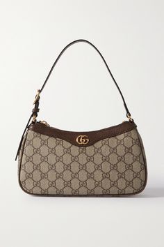 Gucci's bag is part of the 'Ophidia' collection, coveted for its timeless silhouettes. It's been crafted in Italy from printed coated-canvas, trimmed with textured-leather and embellished with the signature, gold-tone 'GG' motif. There's just enough room inside for a few essentials. Designer Bags Gucci, Purse Gucci, Fancy Purses, Dream Bags, Luxury Bags Collection, Latest Handbags, Gucci Handbag, Handbag Essentials, Gucci Ophidia