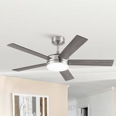 a ceiling fan in a living room with white walls