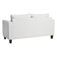 a white couch sitting on top of a wooden table