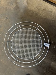 a metal grate sitting on top of a cement floor