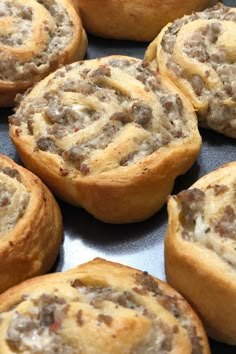 there are many small pastries in the pan together on the table and ready to be eaten