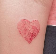 a fingerprint in the shape of a heart on someone's left arm,