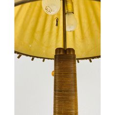 a lamp that is sitting on top of a wooden pole with two lights attached to it