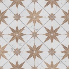 a white and brown tiled floor with star designs on it's sides, in the middle