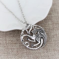 Material: alloy Chain: 26inches ( no clasp) Pendant size: 3.5cm x3cm Come with a gift box Reg: $45 Daenerys Targaryen Necklace, Daenerys Targaryen Dragon Necklace, Daenerys Targaryen Dragons, House Velaryon, Game Of Thrones Necklace, Badge Necklace, Game Of Thrones Jewelry, Game Of Throne Daenerys, Song Of Ice And Fire