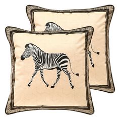 two pillows with zebras on them, one is beige and the other is black