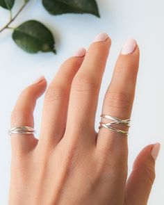 This beautiful wrapped ring will become a staple in your wardrobe! This ring is handcrafted out of a D-shaped (half round) wire, and is a thicker take on our classic wrap-style ring. This listing is for ONE single ring in STERLING SILVER. SIZING NOTE: Because this style is wider than a classic Stacking Ring, we recommend sizing up* by a QUARTER to a HALF size from your US Fashion Ring Size (Bridal size is different than US Fashion Ring Sizing!). Sizing up when purchasing a larger ring style will Modern Twisted Rings As A Gift, Modern Twist Stackable Rings For Promise, Modern Twist Stackable Twisted Promise Rings, Stackable Twisted Rings For Promise, Elegant Twisted Stackable Rings As Gift, Adjustable Twisted Wedding Rings, Modern Twist Infinity Stackable Rings, Minimalist Adjustable Twisted Rings, Modern Twist Stackable Adjustable Midi Rings