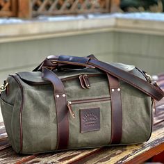 There are lots of duffle bags out there. Most are big and unruly. We set out to create a waxed canvas duffle bag that evokes the rich history of Bushcraft and the pioneers that continue to forge a relationship with nature and survival. Inspired by the mighty Clear Creek, which flows through Golden Colorado this hand made creation is just shy of 28 L of capacity and made from 100% cotton 18 ounce waxed canvas in our signature sage or olive color with a premioum bridle leather trim. Inside you wil Waxed Canvas Duffle Bag, Solar Stove, Golden Colorado, Canvas Duffle Bag, Fuel Wheels, Atv Accessories, Duffle Bags, Duffel Bags, Olive Color